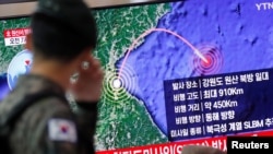 FILE - A South Korean soldier walks past a TV broadcasting a news report on North Korea firing a missile that is believed to be launched from a submarine, in Seoul, South Korea, Oct. 2, 2019. 