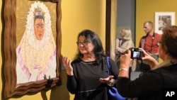 Guests attend a preview of a new exhibition featuring works by Mexican artists Frida Kahlo and Diego Rivera, in Poznan, Poland, Sept. 26, 2017.