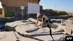 An archaeology expert catalogues destroyed artifacts at Nimrud, south of Mosul, Iraq, Jan. 3, 2025. Once the crown jewel of the ancient Assyrian empire, the UNESCO-listed archaeological site was ravaged by Islamic State fighters after they seized areas of Iraq and Syria in 2014. 