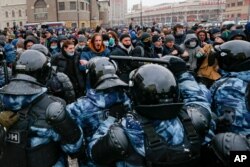 People clash with police during a protest against the jailing of opposition leader Alexei Navalny in Moscow, Jan. 31, 2021.