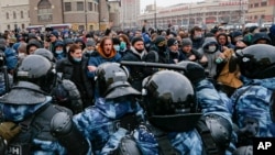 People clash with police during a protest against the jailing of opposition leader Alexei Navalny in Moscow, Jan. 31, 2021. 