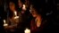 Natalynn Rivis, a student at University of Nevada Las Vegas, right, takes part in a vigil Monday, Oct. 2, 2017, in Las Vegas, Nevada.