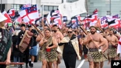 Indigenous Māori people walk through the streets of Wellington, New Zealand to protest against a proposed law that would redefine the country's founding agreement between Indigenous Māori and the British Crown, Nov. 19, 2024.