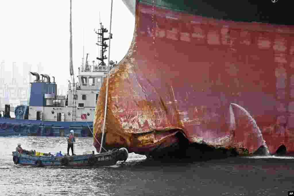 This photo released by Xinhua News Agency shows a view of the damaged part of the Ever Given container ship berthed at a ship-repairing dock of Qingdao Beihai Shipbuilding Heavy Industry Co., Ltd. in Qingdao in eastern China&#39;s Shandong Province, Oct. 4, 2021.
