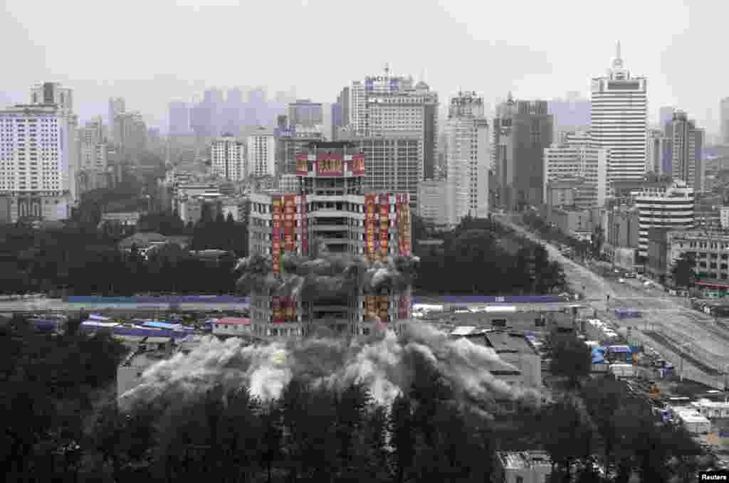 Worker&#39;s Cultural Palace is demolition by explosives in Kunming, Yunnan province, China. The 70-meter-high building had been a recreational center for residents since completion in 1982.&nbsp;