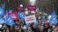 People demonstrate with red signs reading 'One father, one mother, it's obvious,' in Paris, Sunday, January 13, 2013. 