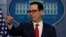 Treasury Secretary Steven Mnuchin points to a reporter to take a question during the news briefing at the White House, in Washington, Aug. 25, 2017. 