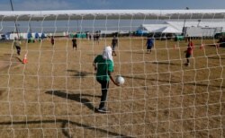 Migrants play soccer at the U.S. government's newest holding center for migrant children in Carrizo Springs, Texas, July 9, 2019.