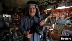 Youssef Akkar, 80, an Iraqi retired teacher poses for a picture in his museum at home in Najaf, Iraq, Feb. 21, 2019. 