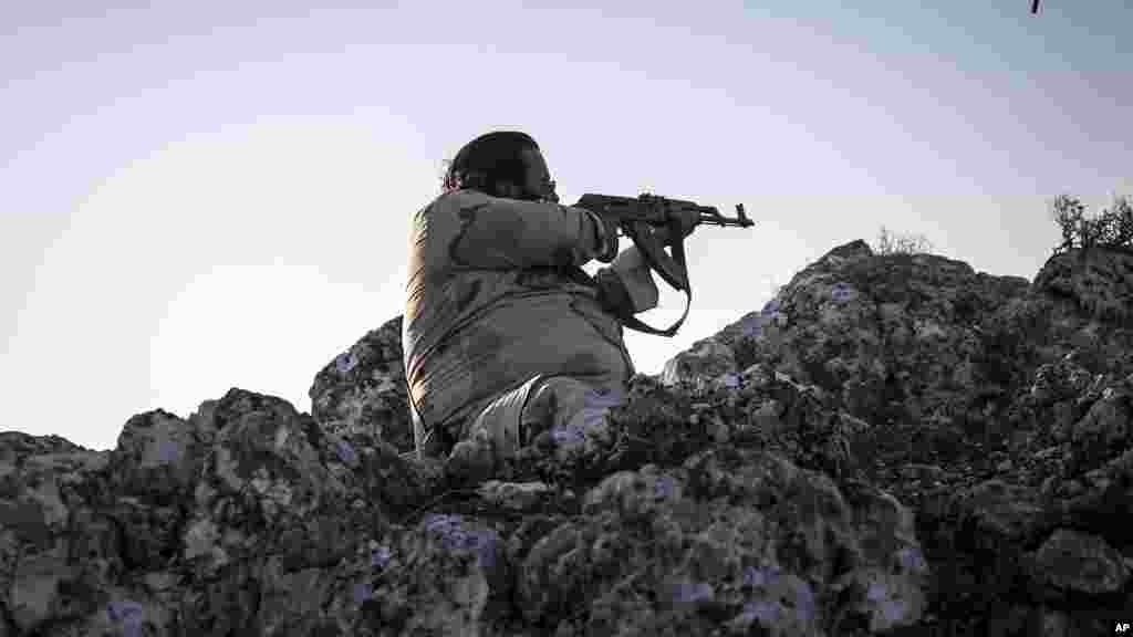 A Syrian opposition fighter aims at government forces in Telata village, Sept. 29. 2013.