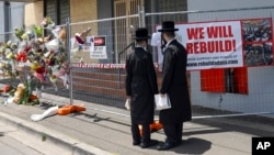 FILE - People gather outside the fire damaged Adass Israel Synagogue in Melbourne, Monday, Dec. 9, 2024. 