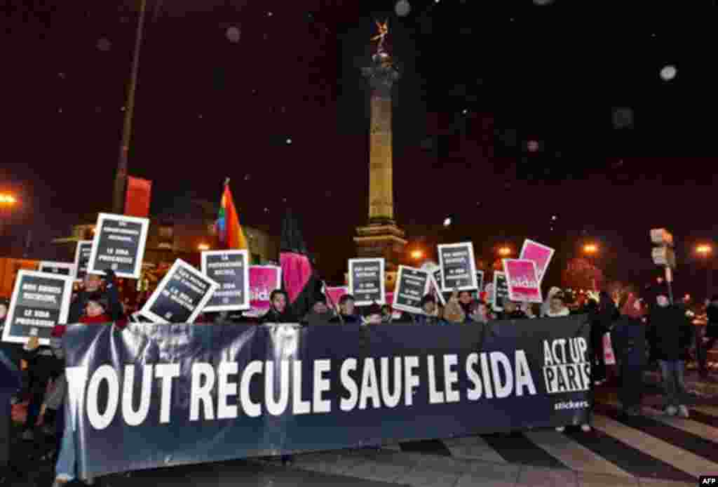 People demonstrate to mark the World AIDS Day, at Bastille place in Paris, Wednesday Dec. 1, 2010. An United Nations report has revealed that nearly 33.4 million people are infected by the HIV virus throughout the world. The banner reads Everything move