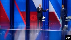 President Joe Biden, accompanied by CNN journalist Don Lemon, right, speaks at a CNN town hall at Mount St. Joseph University in Cincinnati, July 21, 2021.