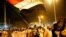 Sudanese people chant slogans and wave Sudanese flags during a demonstration in Khartoum.