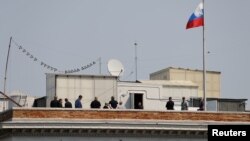 People are seen on the rooftop at the Consulate General of Russia in San Francisco, California, Sept. 2, 2017. 
