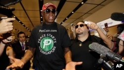 Former NBA basketball player Dennis Rodman arrives at Singapore's Changi Airport, June 12, 2018.