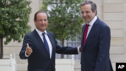 France’s President Francois Hollande, left, welcomes Greece's Prime Minister Antonis Samaras at the Elysee Palace, Paris, August 25, 2012.