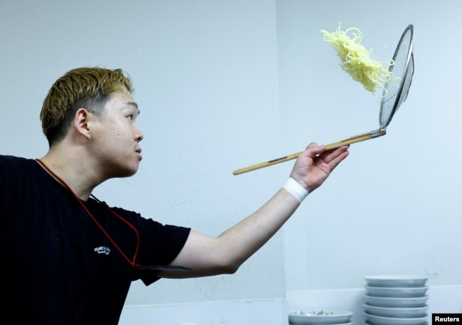 Ramen shop Menya Taisei's owner Taisei Hikage cooks ramen at his shop in Tokyo, Japan, October 22, 2024. (REUTERS/Kim Kyung-Hoon)