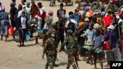 FILE - Soldiers patrol the streets in the Kifangondo District in Luanda on May 13, 2020. 