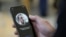 FILE - An Apple employee demonstrates the facial recognition feature of an iPhone in San Francisco. A new Apple tool called "neuralMatch" will detect known images of child sexual abuse on phones without decrypting people's messages.