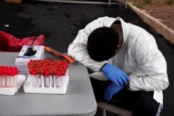 People wait in long lines for COVID-19 testing in Houston, Texas, Sep. 21, 2020.