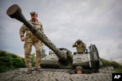 Ukrainian soldiers on a Swedish CV90 infantry fighting vehicle at their positions near Bakhmut, Donetsk region, Ukraine, Sunday, June 25, 2023.