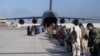 FILE - Passengers board a U.S. Air Force C-17 Globemaster III at Hamid Karzai International Airport, Afghanistan, August 24, 2021. (US Air Force Photo)