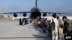 Passengers board a US Air Force C-17 Globemaster III at Hamid Karzai International Airport, Afghanistan, August 24, 2021. (US Air Force Photo)