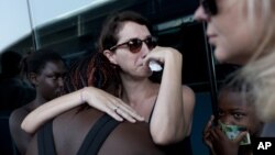 President Barack Obama speaks to a visitor at Arlington National Cemetery in Arlington, Virginia.