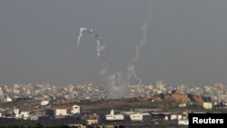 Trails of smoke are seen after the launch of rockets from the northern Gaza strip towards Israel, November 11, 2012. 