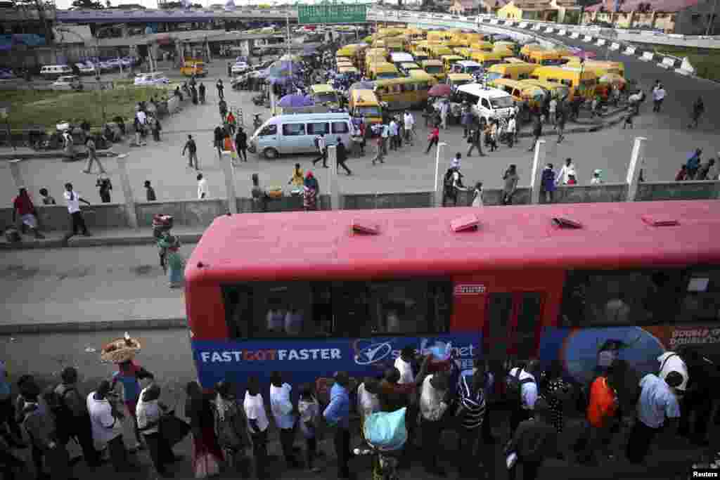 People queue to board a bus in the Obalende district of Lagos.