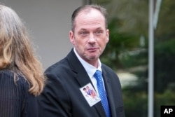 David Smith displays a photograph  of his 2  boys arsenic  helium  walks to a property   league  aft  a parole proceeding  for convicted murderer Susan Smith successful  Columbia, South Carolina, Nov. 20, 2024.