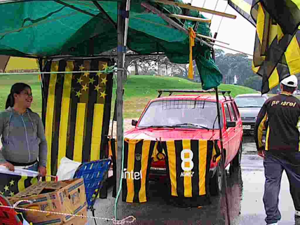 Evelyn Sadur, de 19 años, trabaja en el negocio familiar de fabricación y venta de banderas de fútbol. Este 15 de junio vende las de Peñarol, equipo del que es hincha, frente al Estadio Centenario.