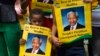 A boy holds a poster with an image of former South African President Nelson Mandela near Qunu, Dec. 13, 2013. 