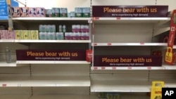 Empty shelves and signs on the soft drinks aisle of a Sainsbury's store in Rowley Regis in the West Midlands, England, July 22, 2021.