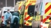 Medics help a patient out of an ambulance at the Royal London Hospital, amid the coronavirus outbreak, in London, Britain, Jan. 5, 2021. 