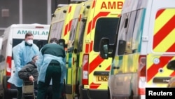 Medics help a patient out of an ambulance at the Royal London Hospital, amid the coronavirus outbreak, in London, Britain, Jan. 5, 2021. 