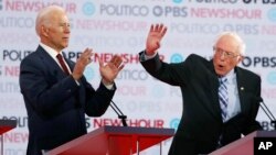 Democratic presidential candidates former Vice President Joe Biden, left, and Sen. Bernie Sanders, speak during a Democratic presidential primary debate, Dec. 19, 2019, in Los Angeles.