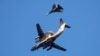 FILE - A Russian air force Beriev A-50 early-warning aircraft, with a Sukhoi Su-27 jet fighter, flies in Kaliningrad, Russia, April 25, 2020.