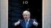 Britain's Prime Minister Boris Johnson shows thumbs up before he applauds on the doorstep of 10 Downing Street in London during the weekly "Clap for our Carers," April 30, 2020. 