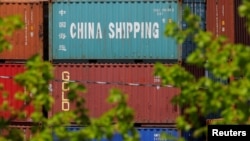  FILE - Shipping containers are stacked at the Paul W. Conley Container Terminal in Boston, May 9, 2018. 