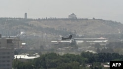 A U.S. military helicopter is pictured flying above the U.S. embassy in Kabul, Afghanistan, Aug. 15, 2021.