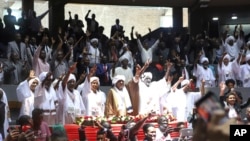 Delegates sing during a planned signing ceremony of the Sudan Founding Charter aimed at establishing a unity government involving leaders of political forces, armed groups and the Rapid Support Forces at the Kenyatta International Convention Centre in Nairob on Feb. 18, 2025. 