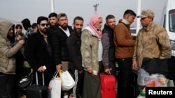 Syrian migrants wait to cross into Syria after Syrian rebels ousted President Bashar al-Assad, at Cilvegozu border gate in Hatay province, Turkey, Dec. 11, 2024.