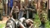 Former hostages who were freed by the military after being held by armed men from the Central African Republic, are seen with chains on their hands and legs after being returned to Cameroon, June 6, 2018. 