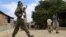 FILE - A Somali soldier patrols a street following a suicide car bomb and gun attack in Afgoye, Somalia, Oct. 19, 2016.