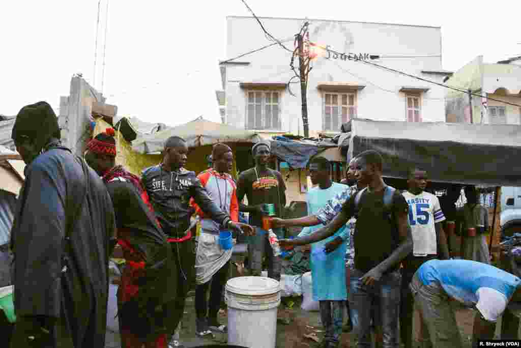 Members of Senegal’s Baye Fall community prepare “Cafe Touba” to hand out to passers-by as fasting hour ends during the month of Ramadan in Dakar.