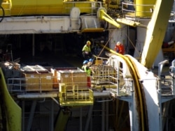 Workers on Nexans Skagerrak vessel lay a NordLink subsea interconnector power cable to connect Norway and Germany at the Vollesfjord fjord near Flekkefjord, Norway May 31, 2018.