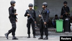 FILE - Indonesian police stand guard at the site of a militant attack in central Jakarta, Indonesia, Jan. 16, 2016. Police say six Islamic militants planned to attack police officers in East Java, but they were killed in a standoff first. 