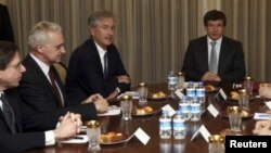 Turkey's Foreign Minister Ahmet Davutoglu (R) and U.S. Deputy Secretary of State William Burns (3rd L) meet as they are flanked by U.S. officials in Ankara January 9, 2012.